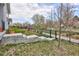 Landscaped backyard featuring a well-maintained lawn and steps leading to a patio area at 655 Stonebridge Dr, Longmont, CO 80503