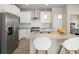 Bright kitchen with stainless steel appliances, subway tile backsplash, and granite island with pendant lights at 655 Stonebridge Dr, Longmont, CO 80503