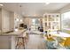 Bright, open-concept living area featuring a kitchen island, dining space, and sliding door to the outside at 655 Stonebridge Dr, Longmont, CO 80503