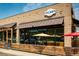 Commercial building exterior with 'CYCLHOPS' signage, featuring a brick facade, awnings, and outdoor seating at 655 Stonebridge Dr, Longmont, CO 80503