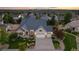 Aerial view of home featuring a three-car garage, manicured lawn, and mature trees at 27235 E Lakeview Pl, Aurora, CO 80016