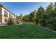 Exterior shot of backyard with lush green lawn and mature landscaping at 27235 E Lakeview Pl, Aurora, CO 80016