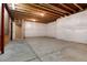 Unfinished basement showcasing concrete floor and walls, with exposed ceiling at 27235 E Lakeview Pl, Aurora, CO 80016