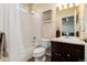 This bathroom features a shower-tub combo and a vanity with a dark wood cabinet at 27235 E Lakeview Pl, Aurora, CO 80016