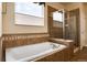 A bright bathroom showcases a tub and shower behind glass doors with decorative tile at 27235 E Lakeview Pl, Aurora, CO 80016