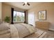 This bedroom features a large window, neutral colors, and double doors at 27235 E Lakeview Pl, Aurora, CO 80016