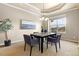 Cozy dining room with a modern chandelier, artful decor, and a large window for natural light at 27235 E Lakeview Pl, Aurora, CO 80016