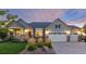 Inviting home showcasing a three-car garage, manicured lawn, and charming stone accents on the exterior at 27235 E Lakeview Pl, Aurora, CO 80016