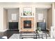 Inviting living room featuring a brick fireplace, stylish decor, and a cozy seating area with natural light at 27235 E Lakeview Pl, Aurora, CO 80016