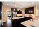 Bright kitchen with dark wood cabinets, granite counters, and stainless steel appliances at 27235 E Lakeview Pl, Aurora, CO 80016