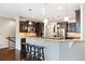 Spacious kitchen with dark wood cabinets, granite counters, and stainless steel appliances at 27235 E Lakeview Pl, Aurora, CO 80016