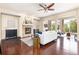 Comfortable living room with wood floors, a brick fireplace, and plenty of natural light from large windows at 27235 E Lakeview Pl, Aurora, CO 80016