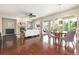 Open living area with wood floors, a cozy fireplace, ample seating, and abundant natural light at 27235 E Lakeview Pl, Aurora, CO 80016