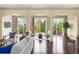 Bright living room boasts hardwood floors and large windows offering scenic backyard views at 27235 E Lakeview Pl, Aurora, CO 80016