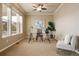 Bright home office featuring a modern desk, neutral walls, and a ceiling fan at 27235 E Lakeview Pl, Aurora, CO 80016