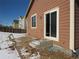 Backyard with partially snow-covered yard, with a sliding glass door to enter the home at 25858 E Bayaud Ave, Aurora, CO 80018