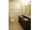 Traditional bathroom featuring a double vanity, a framed mirror, and neutral tiled flooring at 25858 E Bayaud Ave, Aurora, CO 80018