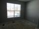 Bedroom featuring a bright window, neutral wall color, and space for new flooring at 25858 E Bayaud Ave, Aurora, CO 80018