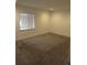 Bright bedroom featuring a neutral color scheme, plush carpeting, and a large window for natural light at 25858 E Bayaud Ave, Aurora, CO 80018