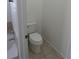 Tiled powder room featuring a toilet at 25858 E Bayaud Ave, Aurora, CO 80018