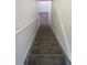 Carpeted stairway with handrail at 25858 E Bayaud Ave, Aurora, CO 80018