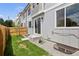 Backyard featuring a small lawn, privacy fence, and a sliding glass door on a modern home at 4020 Upham St, Wheat Ridge, CO 80033