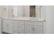 Bathroom featuring double sinks, modern fixtures, and plenty of storage at 4020 Upham St, Wheat Ridge, CO 80033