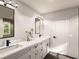 Modern bathroom featuring double sinks, sleek fixtures, stylish mirrors, and contemporary lighting, creating a luxurious retreat at 4020 Upham St, Wheat Ridge, CO 80033