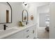 Stylish bathroom features double vanity with sleek fixtures, arched mirrors, and neutral tones, creating a serene atmosphere at 4020 Upham St, Wheat Ridge, CO 80033