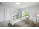 Serene bedroom featuring soft bedding, natural light, and stylish modern decor at 4020 Upham St, Wheat Ridge, CO 80033