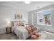 Cozy bedroom with neutral tones, soft textures, natural light, and decorative wall art at 4020 Upham St, Wheat Ridge, CO 80033