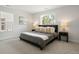 Bright bedroom featuring modern design, large windows, neutral tones, and stylish furniture at 4020 Upham St, Wheat Ridge, CO 80033