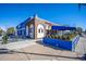Blue and brick exterior of a commercial building, featuring outdoor seating and clear signage at 4020 Upham St, Wheat Ridge, CO 80033