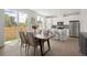Open dining area adjacent to kitchen, featuring modern table and access to outdoor patio at 4020 Upham St, Wheat Ridge, CO 80033