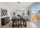 Open-concept dining area with modern light fixture and easy access to the living room and outdoor patio at 4020 Upham St, Wheat Ridge, CO 80033