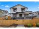 Charming white two-story home with a fenced yard under construction on a sunny day at 4020 Upham St, Wheat Ridge, CO 80033
