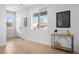 Bright entryway with hardwood floors, a modern console table, and large windows providing plenty of natural light at 4020 Upham St, Wheat Ridge, CO 80033