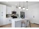 Beautiful kitchen featuring white cabinets, a stainless steel refrigerator, and a center island with barstool seating at 4020 Upham St, Wheat Ridge, CO 80033