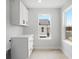 Bright laundry room with ample cabinet storage, natural light, and modern fixtures at 4020 Upham St, Wheat Ridge, CO 80033