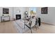 Inviting living room featuring a fireplace, hardwood floors, neutral furniture, and access to the open-concept dining area at 4020 Upham St, Wheat Ridge, CO 80033