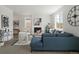 Inviting living room with fireplace, blue sofa, white accent chairs, and an open layout at 4020 Upham St, Wheat Ridge, CO 80033
