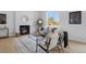 Bright living room boasts a fireplace, large window, light hardwood floors, and decorative rug at 4020 Upham St, Wheat Ridge, CO 80033