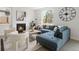 Cozy living room featuring a blue sectional sofa, fireplace, and stylish decor at 4020 Upham St, Wheat Ridge, CO 80033