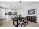 Open-concept living space featuring a modern kitchen, dining room, and living area with plenty of natural light at 4020 Upham St, Wheat Ridge, CO 80033