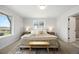 Bright main bedroom featuring a textured rug, bedside tables, and a comfy, inviting bedspread at 4020 Upham St, Wheat Ridge, CO 80033