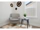 Cozy reading nook with comfortable chair, small table, and natural light from the window at 4020 Upham St, Wheat Ridge, CO 80033