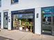 Unique retail space showcasing greenery through a garage door entrance, with an 'OPEN' sign displayed at 4020 Upham St, Wheat Ridge, CO 80033