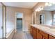 Bathroom featuring a soaking tub, double vanity, and walk-in closet access at 13744 Columbine St, Thornton, CO 80602