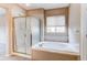 Bright bathroom with a glass-enclosed shower and a large soaking tub at 13744 Columbine St, Thornton, CO 80602