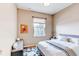Cozy bedroom with hardwood floors, bright painting, and queen bed at 13744 Columbine St, Thornton, CO 80602